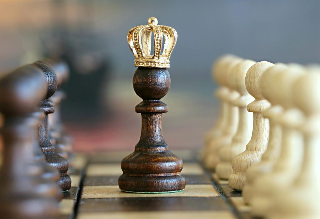 Renovations: Best Salvaging Strategies for Success A brown pawn with a crown stands prominently on a chessboard, symbolizing strategic play.