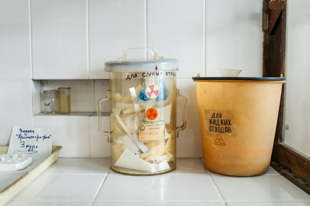 Hazardous Waste Disposal: Budget-Friendly Safety Tips Two containers in a laboratory setting for managing radioactive waste disposal.