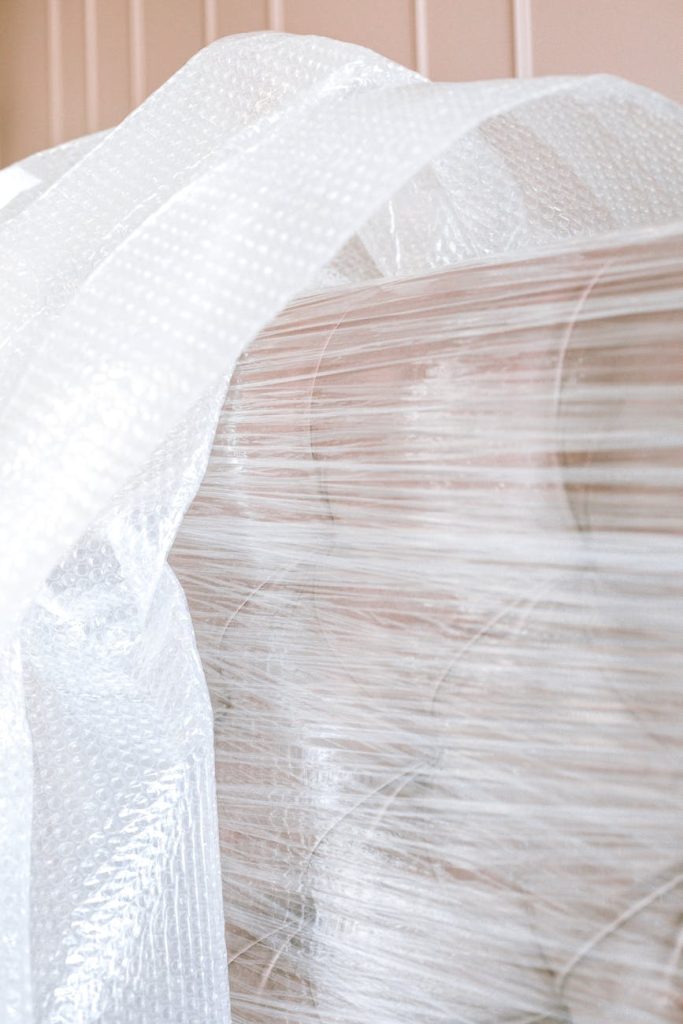 House Removals: Effortless Ways to Safeguard Your Furniture Close-up of a sofa wrapped in bubble wrap, ready for moving or storage.