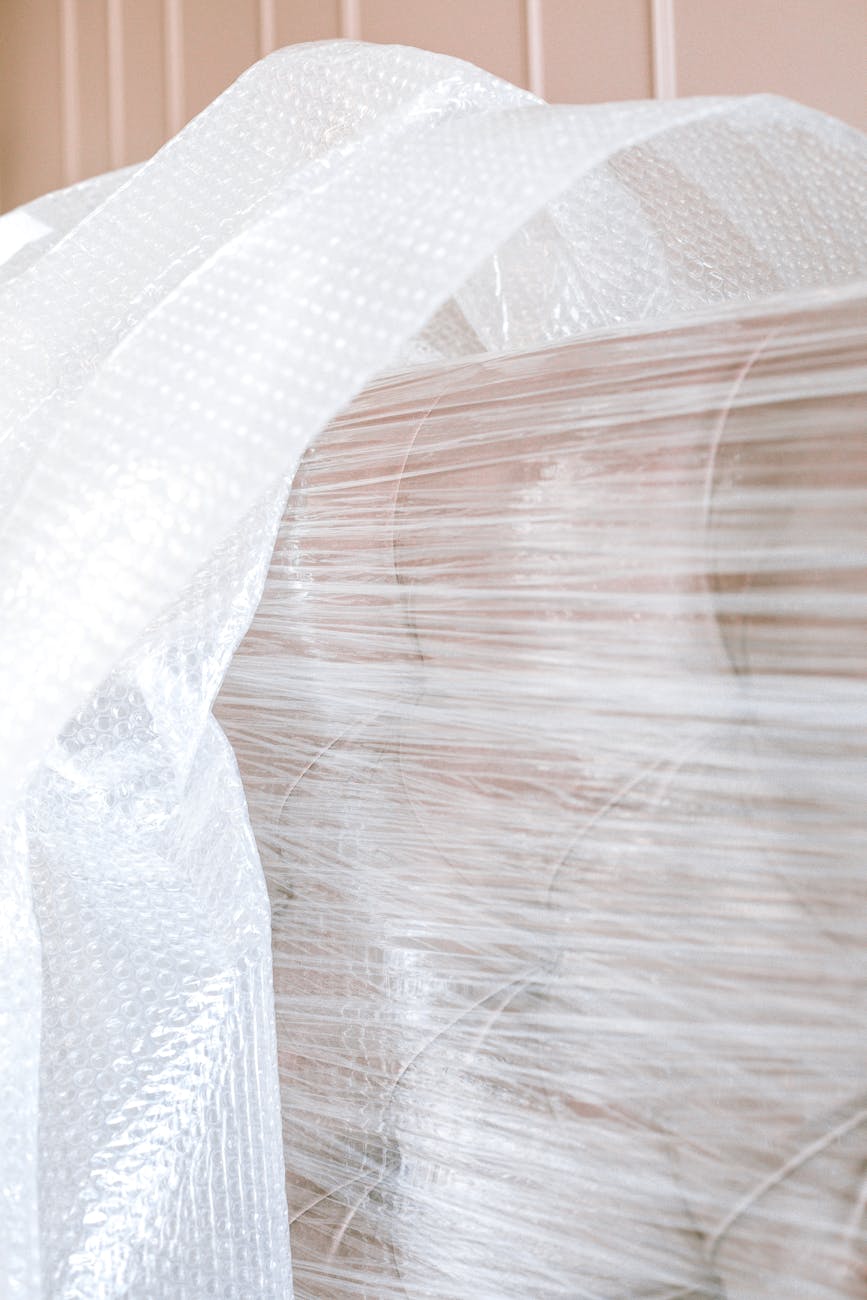 House Removals: Effortless Ways to Safeguard Your Furniture Close-up of a sofa wrapped in bubble wrap, ready for moving or storage.