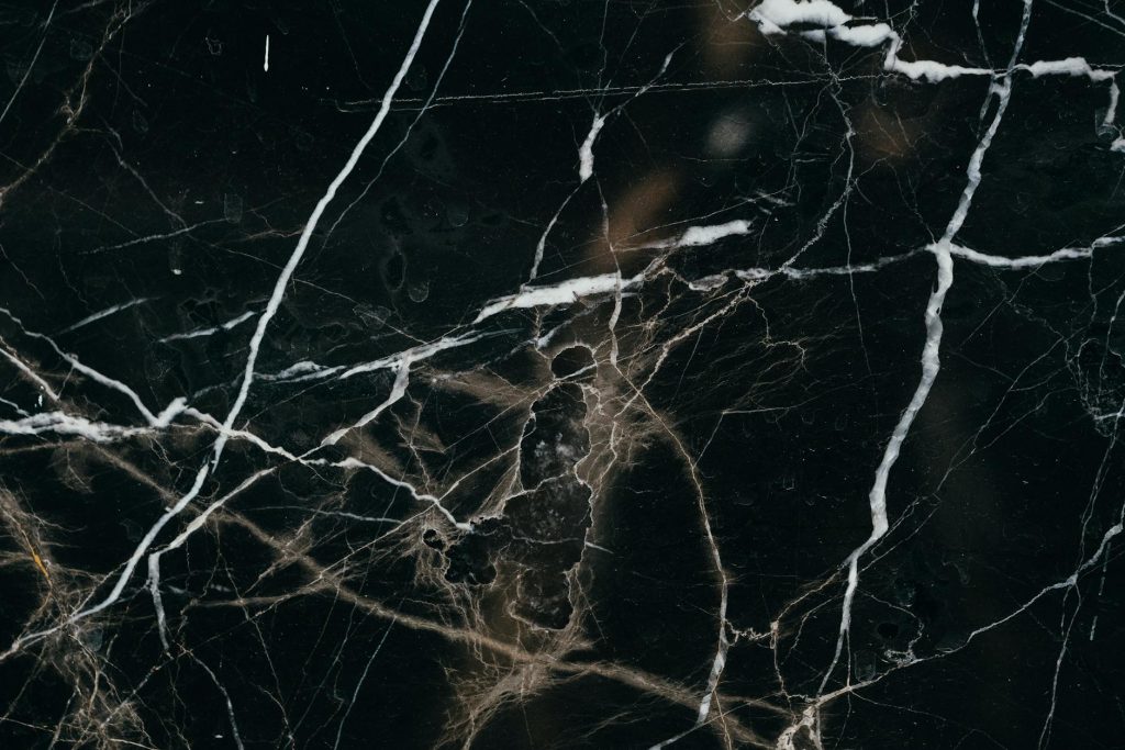 Office Relocation Strategies: Effortless Tips for Multi-Floor Moves Close-up view of a black marble texture, showcasing intricate white veining patterns.