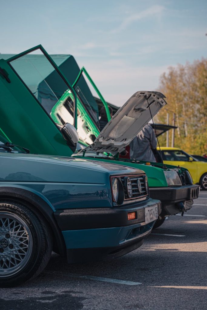 Transporting Multiple Vehicles: 6 Effortless Tips for Success Close-up of vintage cars lined up at an outdoor show in daylight.