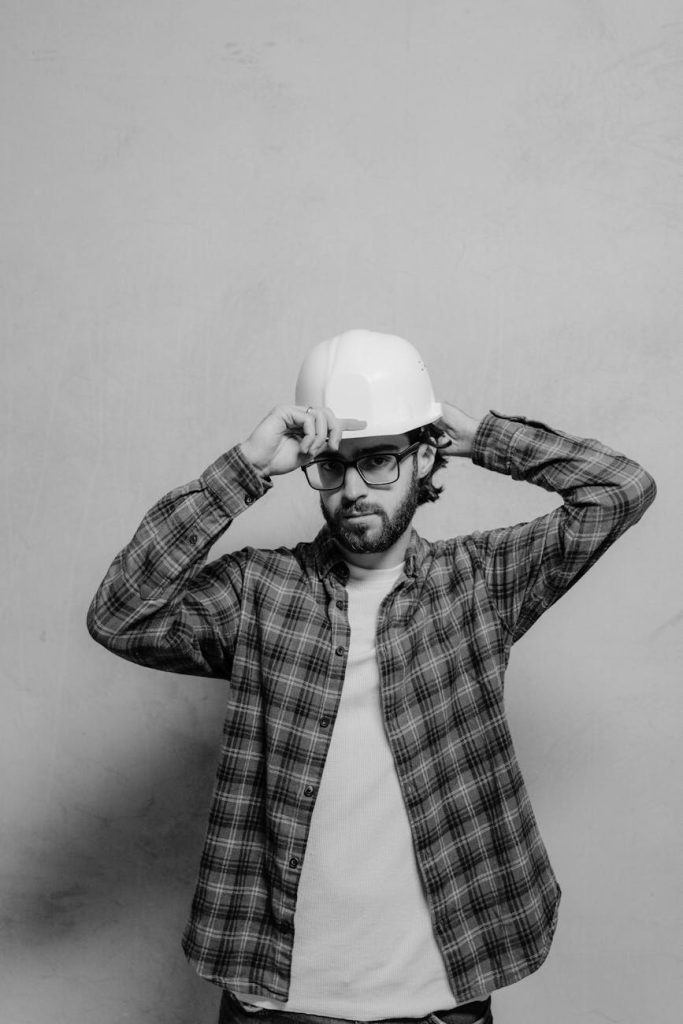 Industrial Removal Planning: Effortless Strategies for Zero Downtime Black and white photo of a male construction worker wearing a hard hat and glasses.