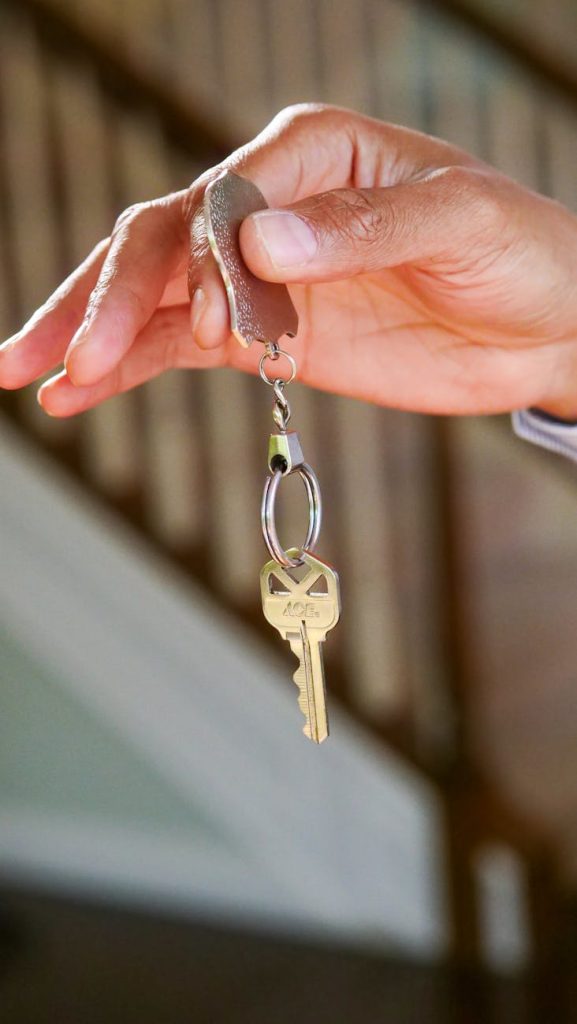 Salvage: The Best Sustainable Solution for Eco-Friendly Moving Close-up of a hand holding a key, symbolizing new homeownership or rental.