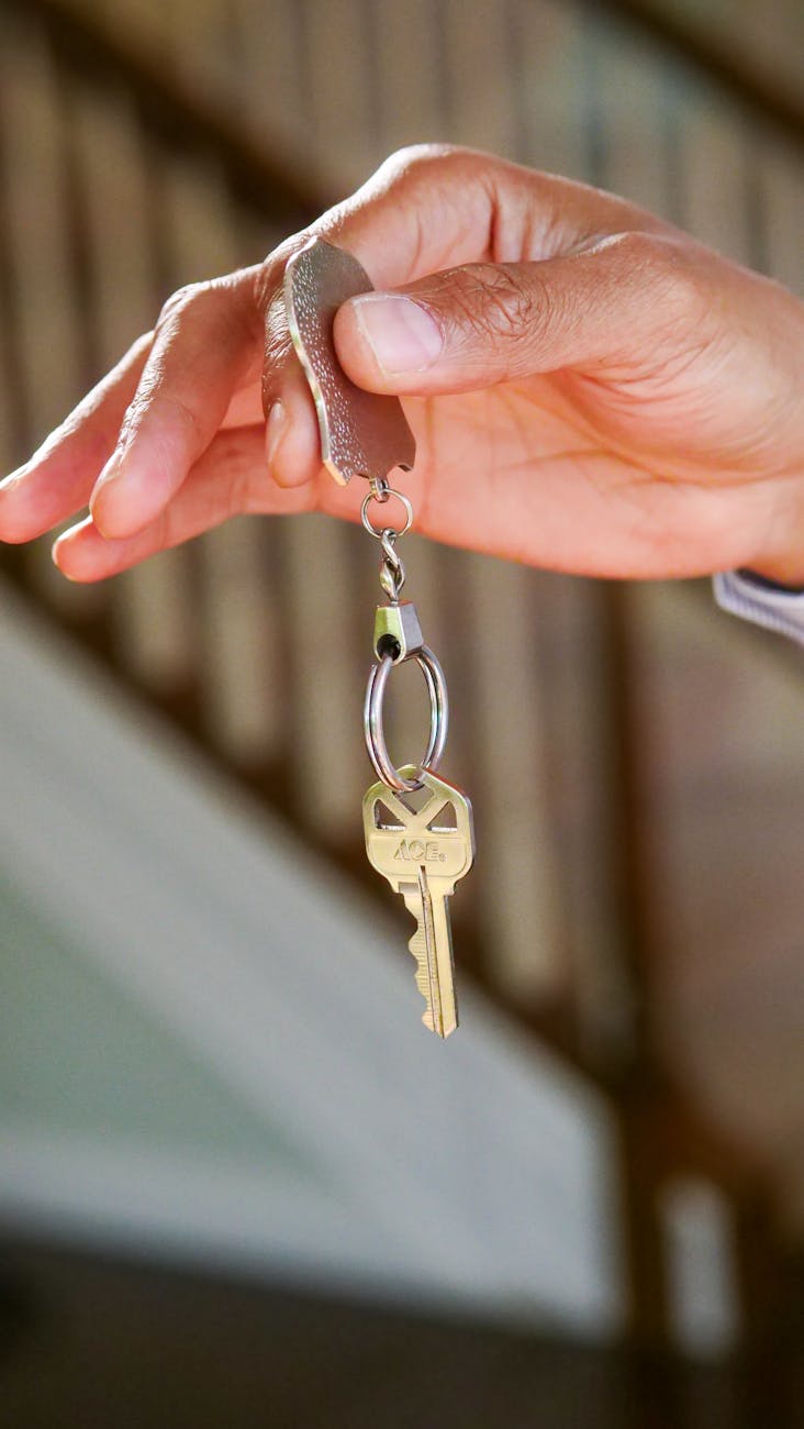 Salvage: The Best Sustainable Solution for Eco-Friendly Moving Close-up of a hand holding a key, symbolizing new homeownership or rental.